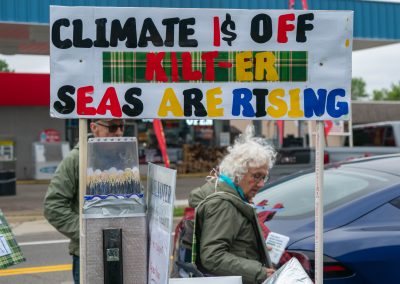 Group of protestors holding a sign at Mt Pleasant Citizens Climate Lobby at Alma Highland Festival 2026 15