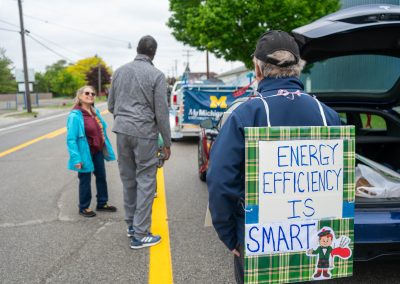 Group of protestors holding a sign at Mt Pleasant Citizens Climate Lobby at Alma Highland Festival 2026 2