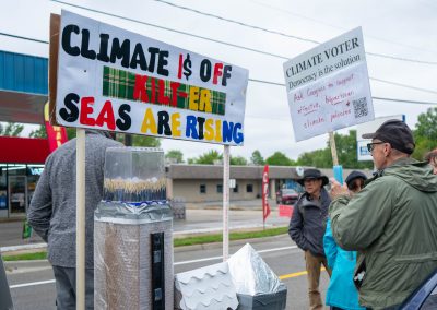 Group of protestors holding a sign at Mt Pleasant Citizens Climate Lobby at Alma Highland Festival 2026 10