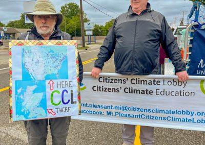 Group of protestors holding a sign at Mt Pleasant Citizens Climate Lobby at Alma Highland Festival 2026 13