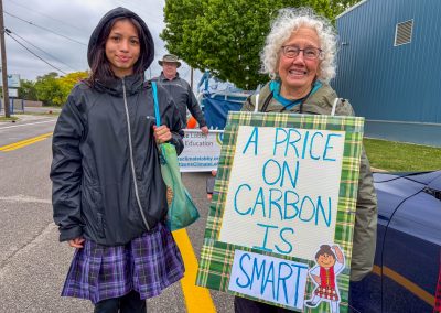 Group of protestors holding a sign at Mt Pleasant Citizens Climate Lobby at Alma Highland Festival 2026 14